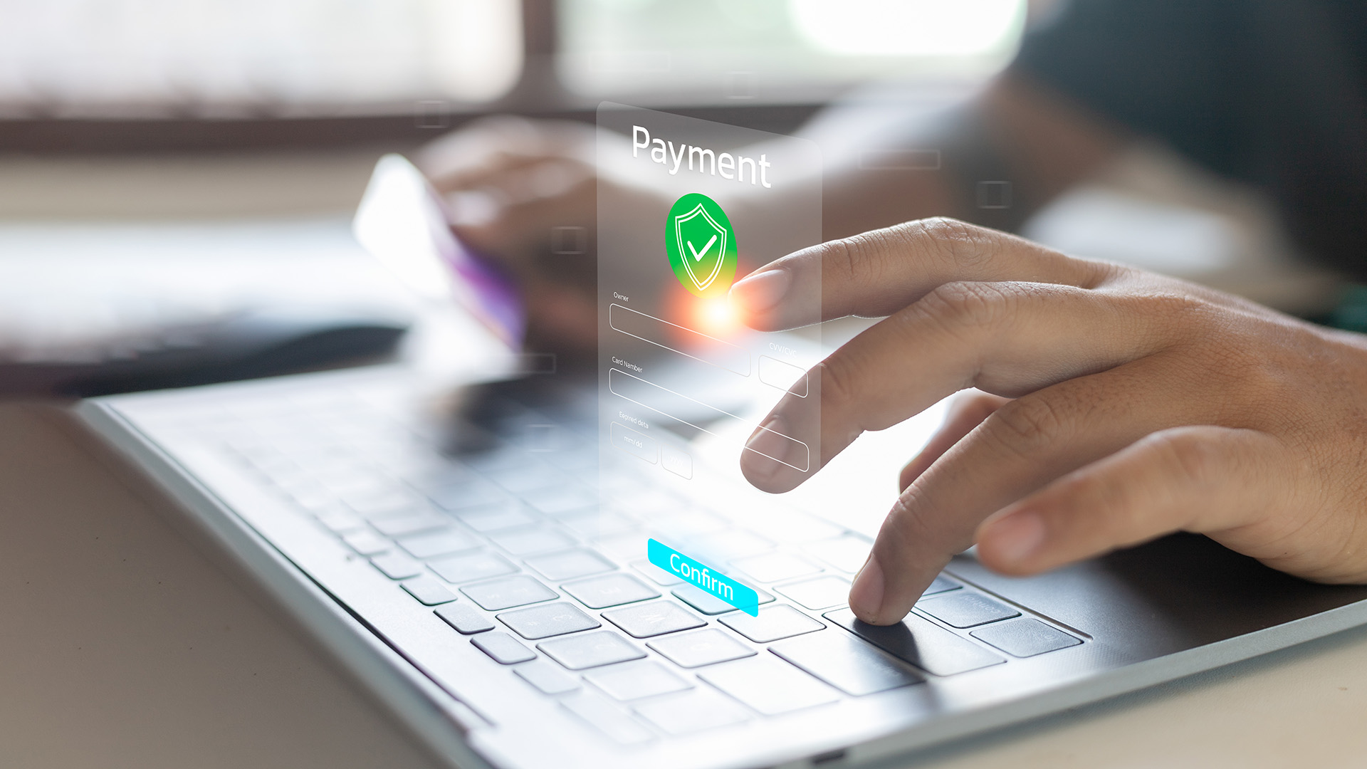 Hands using a keyboard and confirming a digital payment
