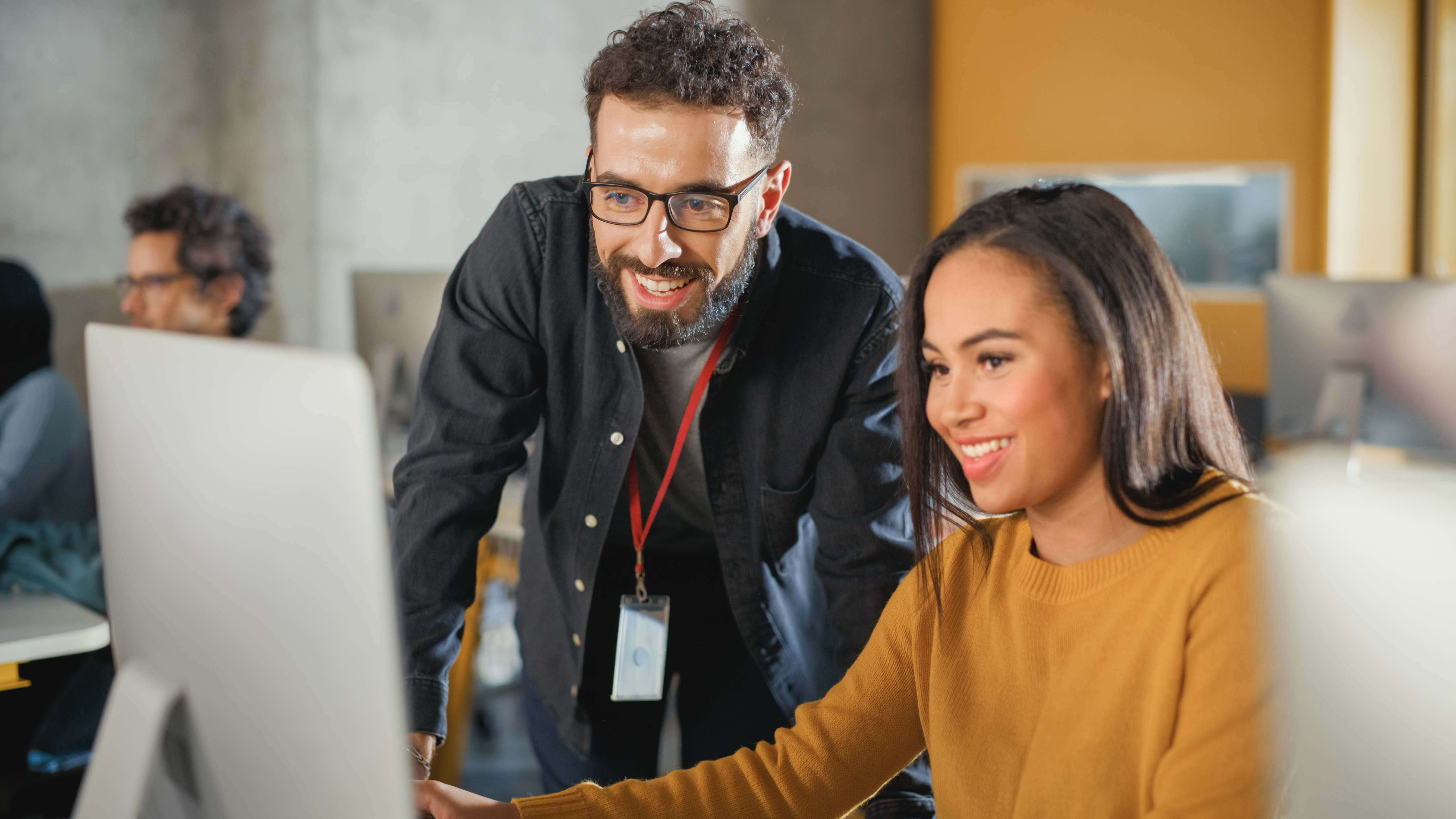 IT professional helping a women at her desktop computer
