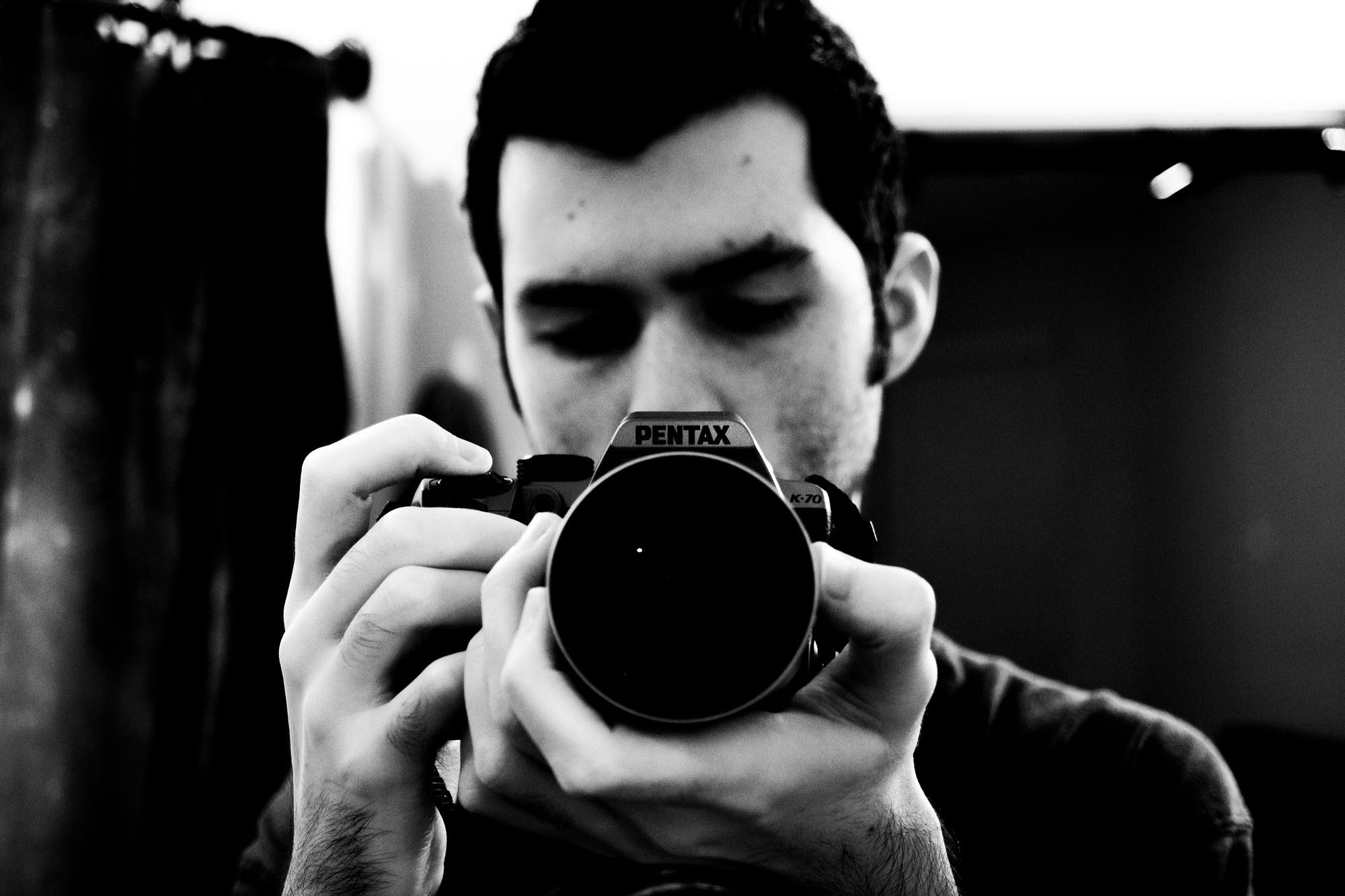 Jake holds up his Pentax camera, lining up a beautiful shot