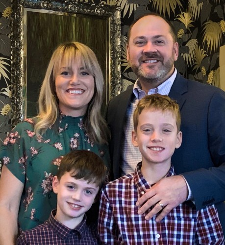 Bob poses for a photo with his wife and two sons