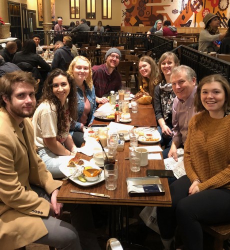 Cindy, her husband and their adult children enjoy a meal together in New York City.