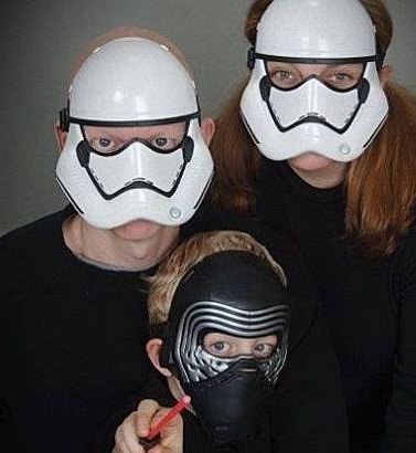 Chris, his wife and son all don Star Wars masks