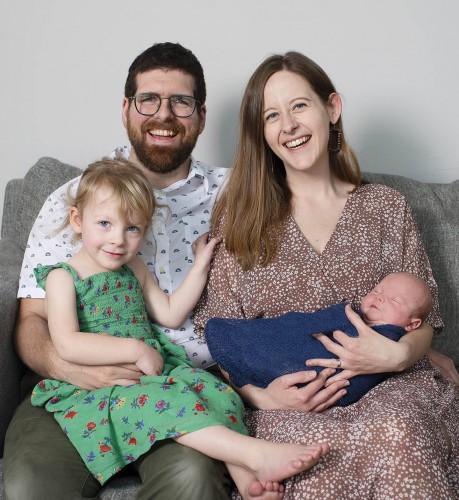 Pierre and his wife Stephanie smile while holding their children, Luna and Arthur.