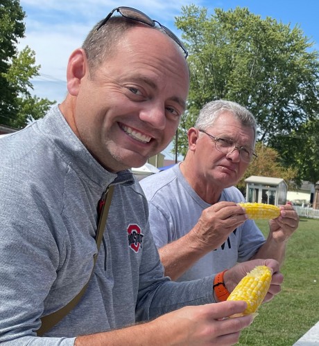 Rich and his dad enjoy some fresh corn at the Millersport Sweet Corn Festival