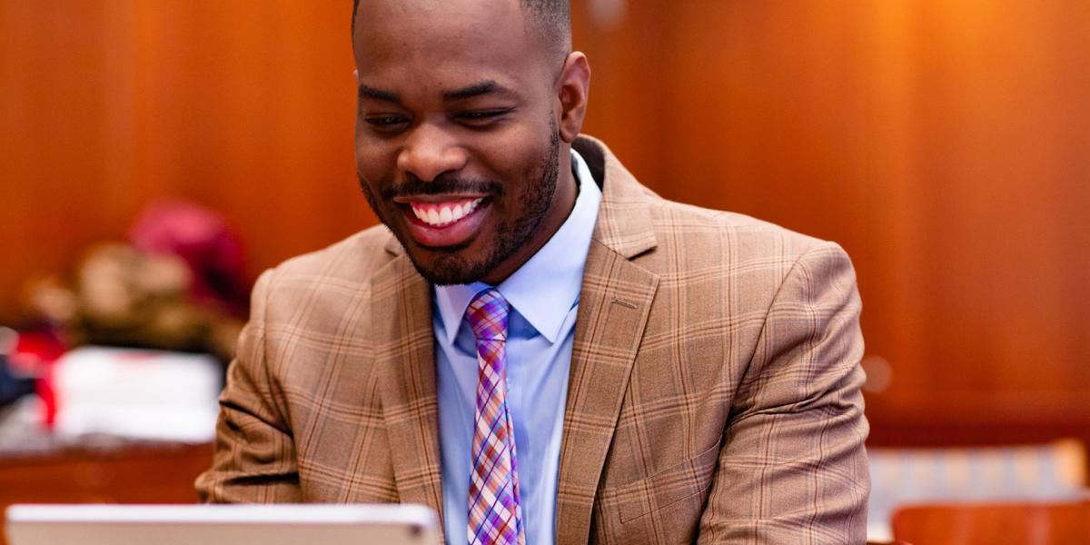 Smiling instructor using a tablet