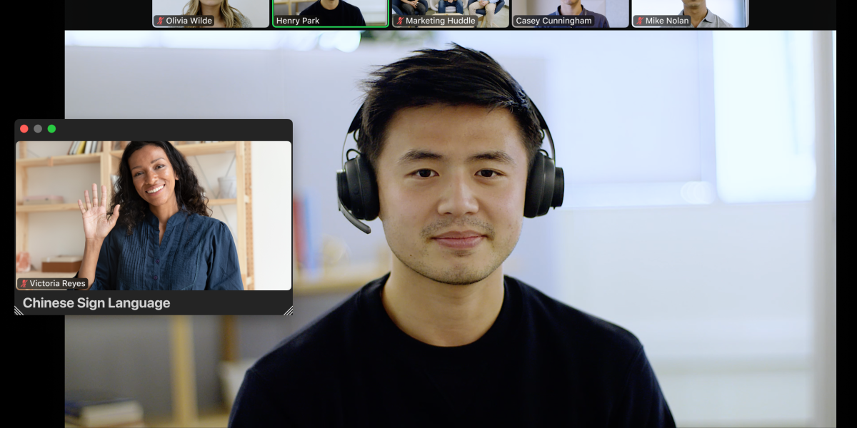 A Zoom meeting with several participants, including a separate window for a sign language interpreter
