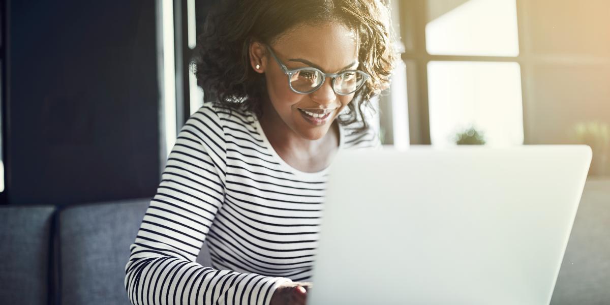 Decorative image of a woman using a laptop device. 