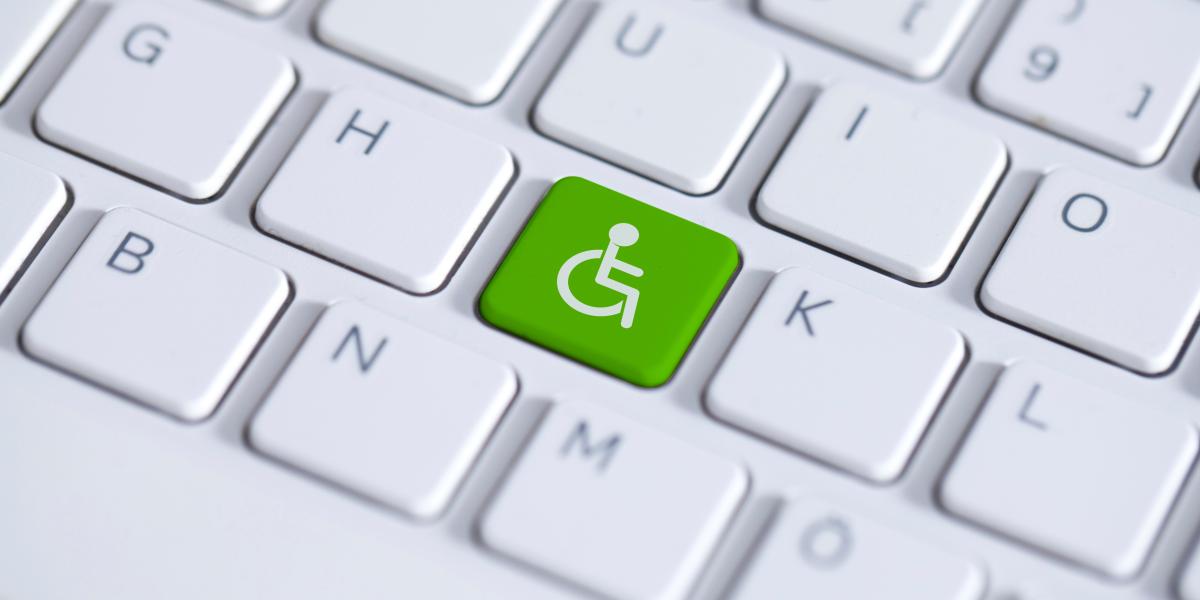 keyboard with an accessibility key in green