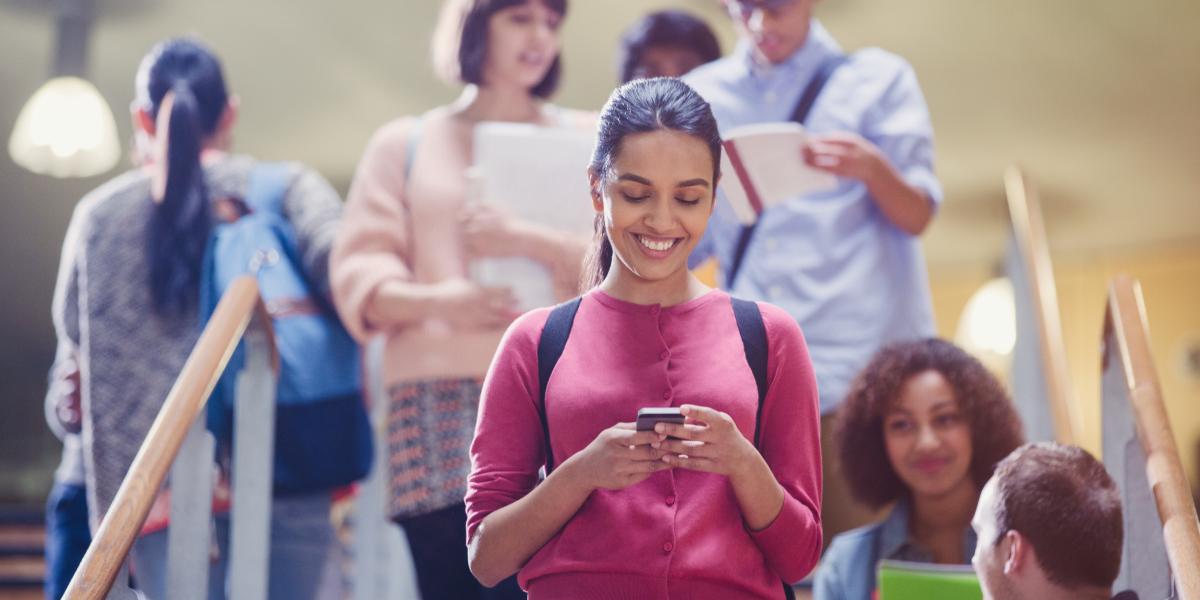 decorative image of student texting while walking