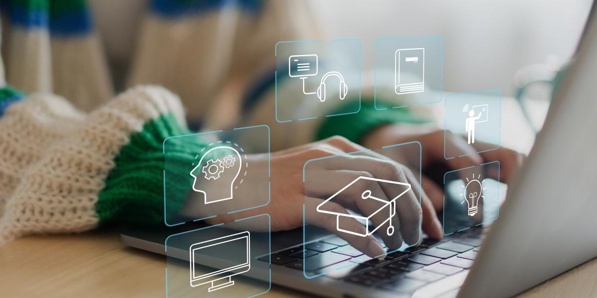 Hands on a keyboard with tiles for ed tech.