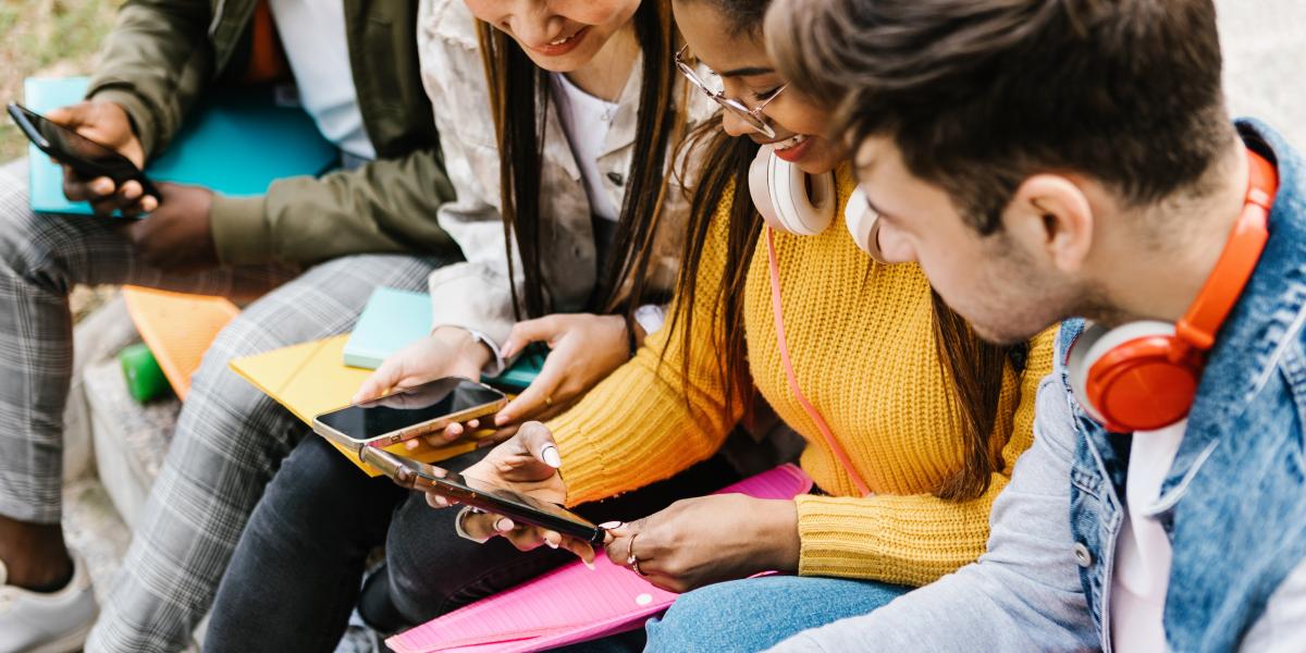 A group of students looking at smartphones.