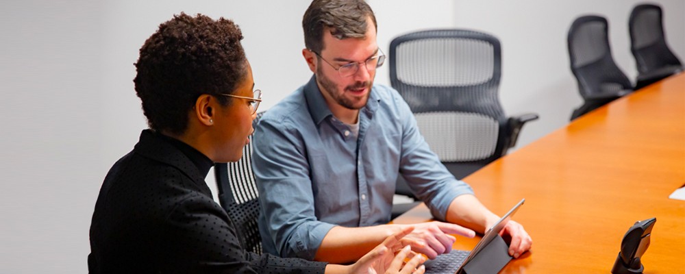 Instructional Designer working with a faculty member using a tablet