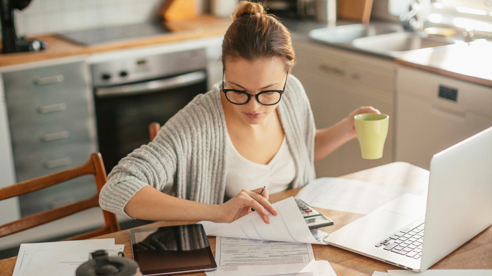 Woman working at home with a laptop computer and tablet