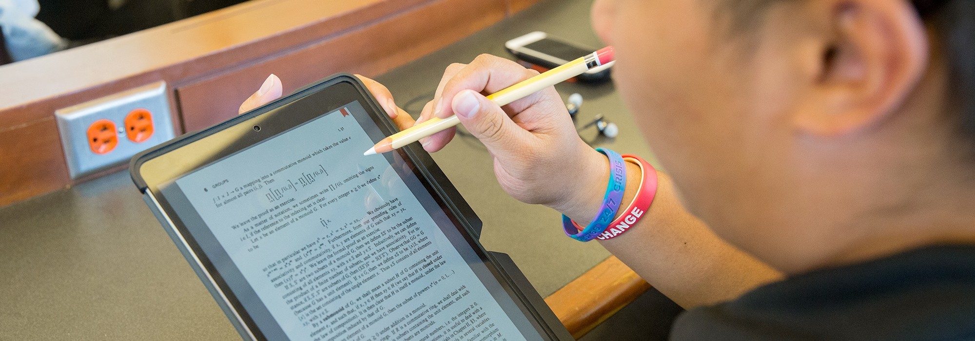 Student using an Apple Pen with an iPad