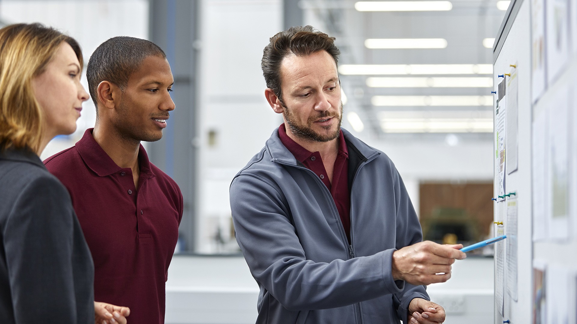 Group of people looking at a project board together