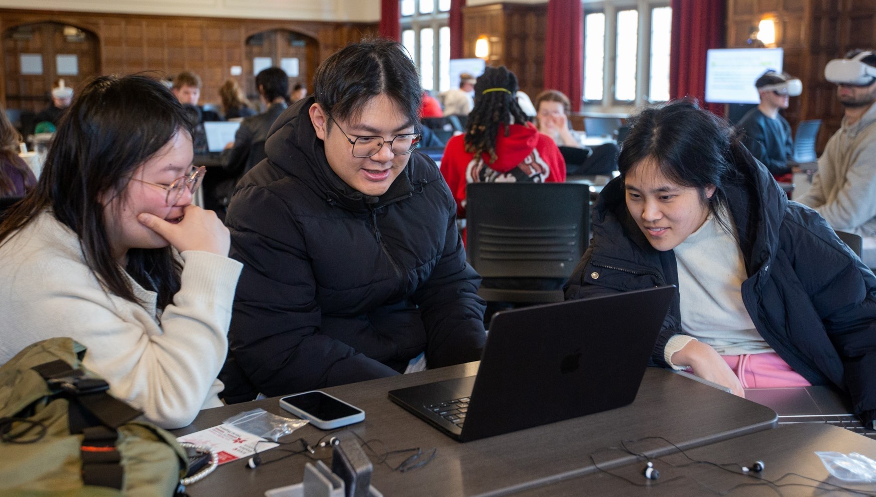 students collaborating on a laptop