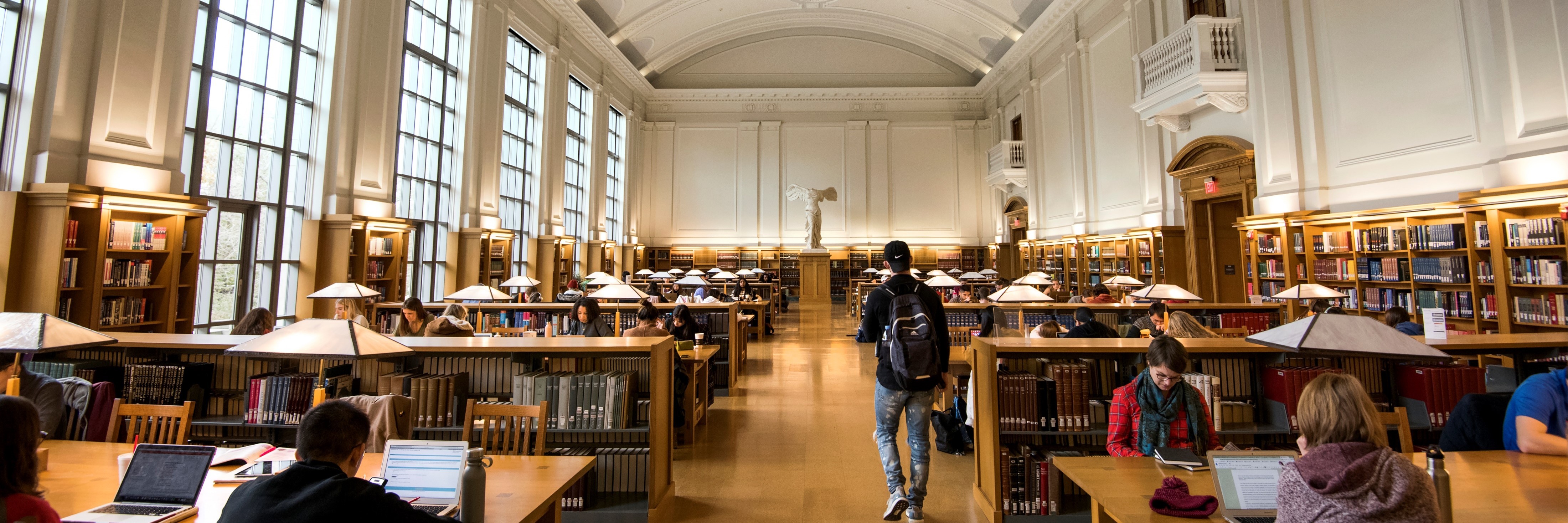 Students walking through library