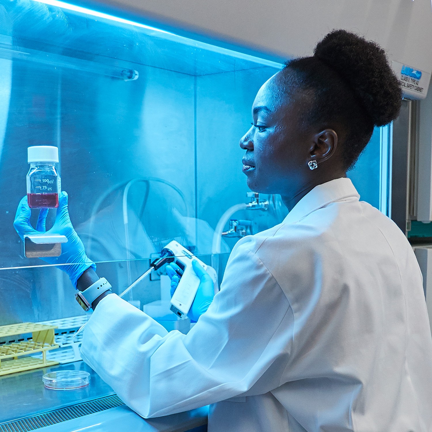 Woman in a lab coat working in a lab