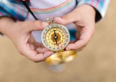 Gold and Silver Compass in Person's Hands