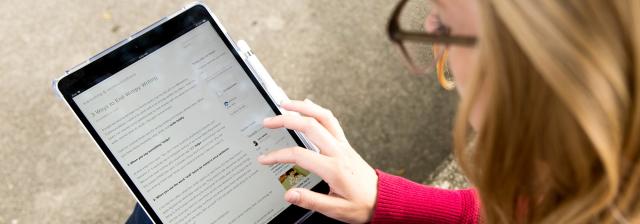 Student using an iPad outside