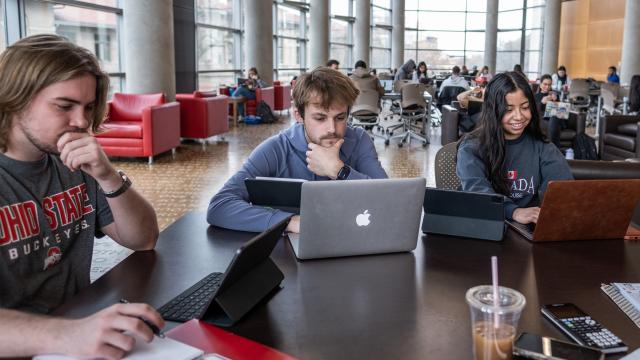 Students using technology in a library