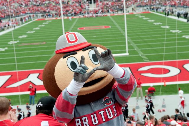 Buckeye Brutus mascot in front of the Ohio Stadium football field