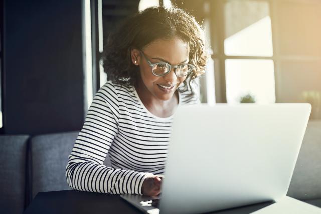 Decorative image of a woman using a laptop device.