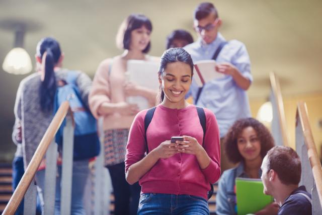 decorative image of student texting while walking