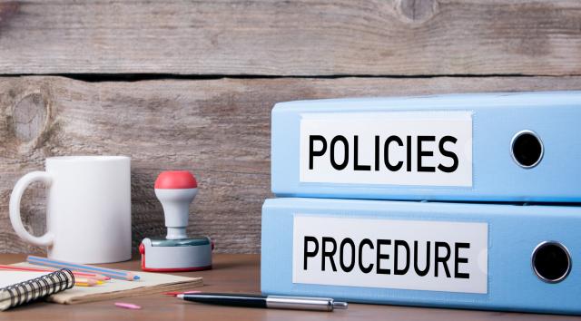 Binders with the labels Policies and Procedures