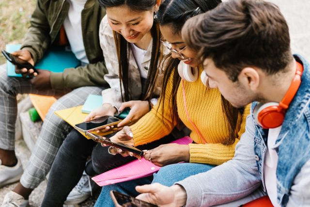 A group of students looking at smartphones.