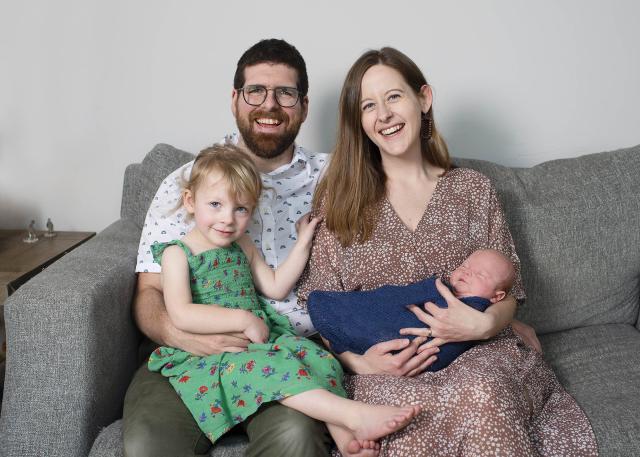 Pierre and his wife Stephanie smile while holding their children, Luna and Arthur.