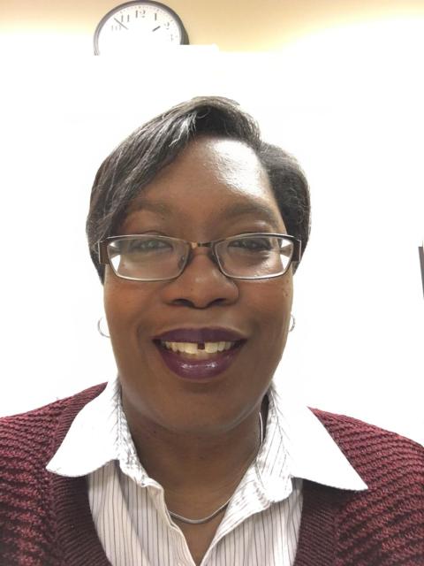 Tracey smiles for a professional headshot