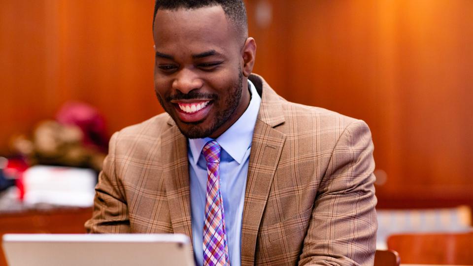 Smiling instructor using a tablet