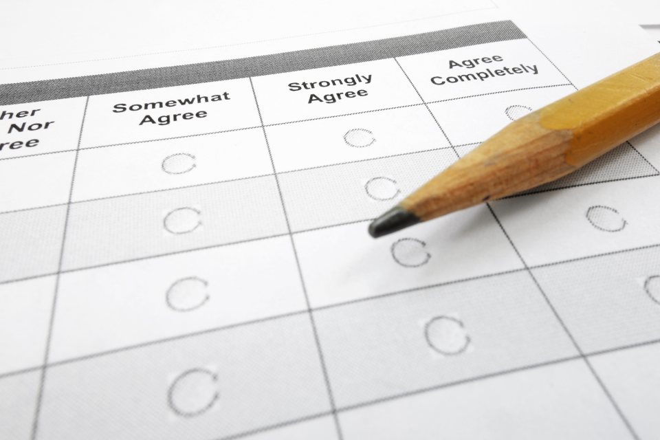 Pencil laying on a printed survey with bubbles to fill in