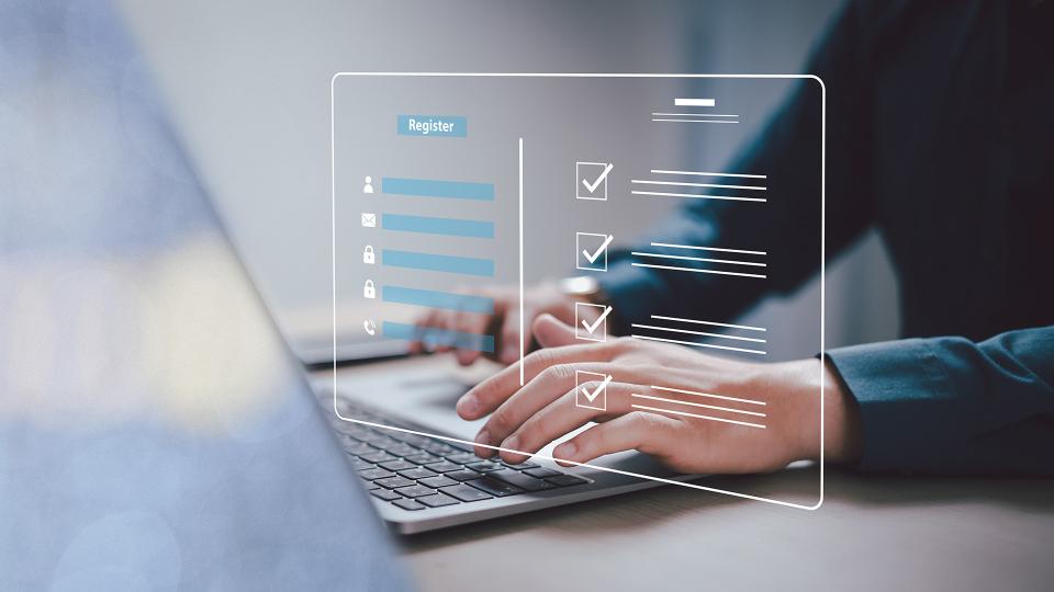 Hands typing information into a registration form