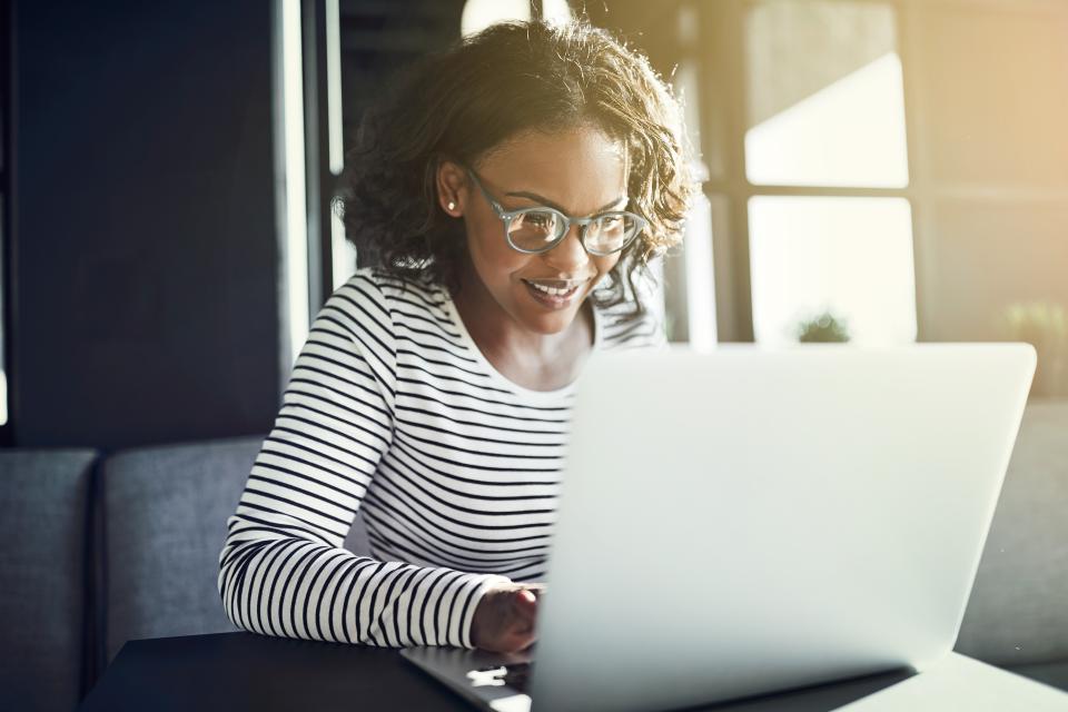 Decorative image of a woman using a laptop device.